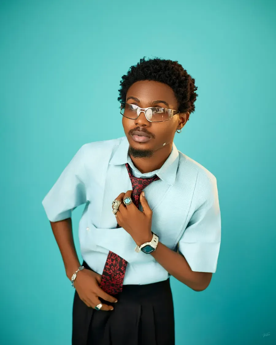 Model in the aqua wrap-front shirt with a red and black printed tie